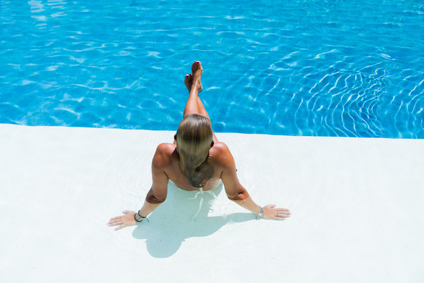 Beautiful woman relaxing in a pool - Fotografie, Obrázek