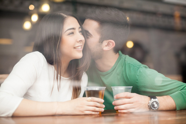 Guy drinking beer at a bar and whispering - Photo, Image