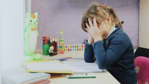 Schoolgirl writing mathematic homework. Depressed, nothing leaves - Footage, Video