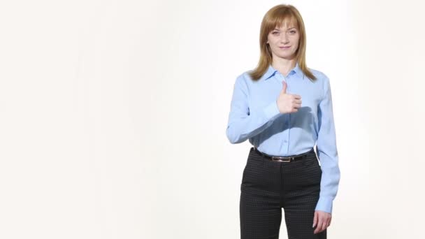 raised thumb. girl in pants and blous.  Isolated on white background. body language. women gestures. nonverbal cues - 映像、動画