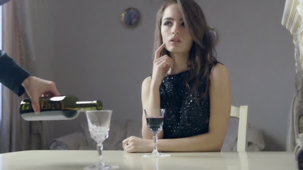 Beautiful girl on a date. Man pours a glass of red wine. - Video