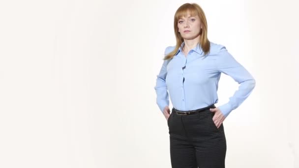 hands in his pockets. thumbs up to the outside. girl in pants and blous.  Isolated on white background. body language. women gestures. nonverbal cues - 映像、動画