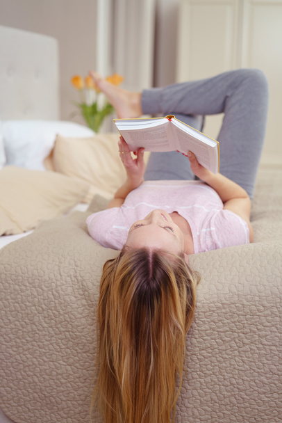 Relaxed young woman reading at home - Foto, Imagem