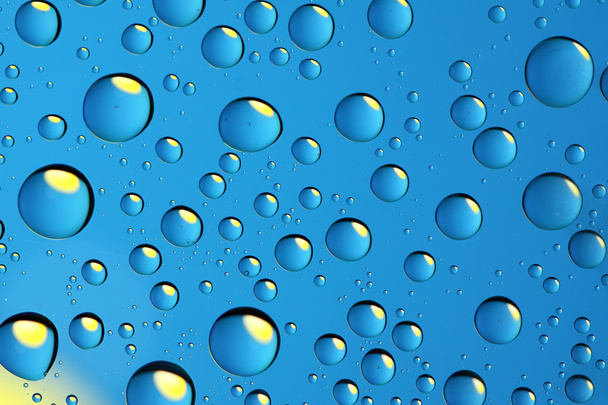 Blue drops with yellow reflection - Zdjęcie, obraz