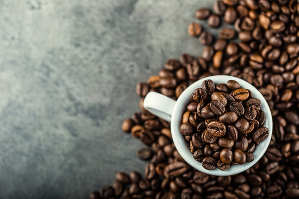 Coffee. Coffee beans. Coffee cup full of coffee beans. Toned image - Фото, зображення