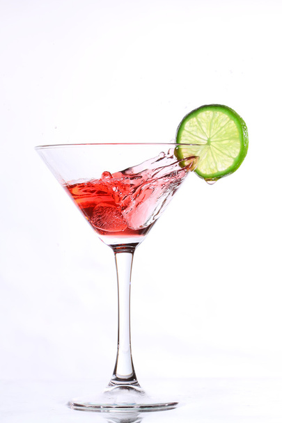 Red cocktail with lime on white - Fotó, kép