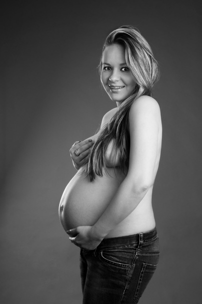 Pregnant woman holding her tummy - Fotoğraf, Görsel