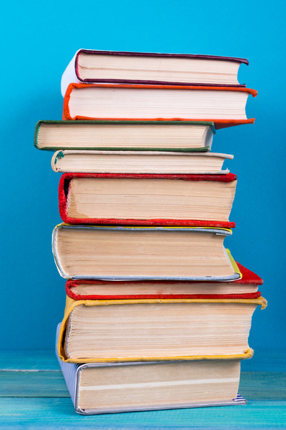 Stack of colorful books, grungy blue background, free copy space - Photo, Image