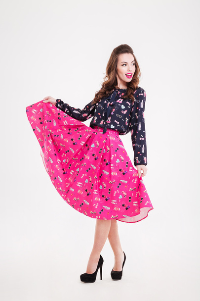 Cheerful attractive young woman in bright pink skirt  - Fotoğraf, Görsel