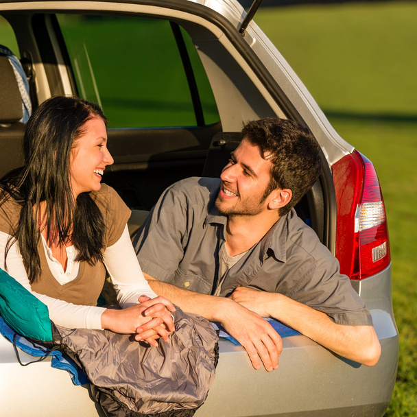 Camping young couple lying car summer sunset - Foto, Imagen
