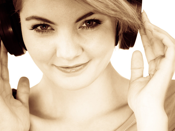 Woman in big headphones listening music isolated - Fotografie, Obrázek