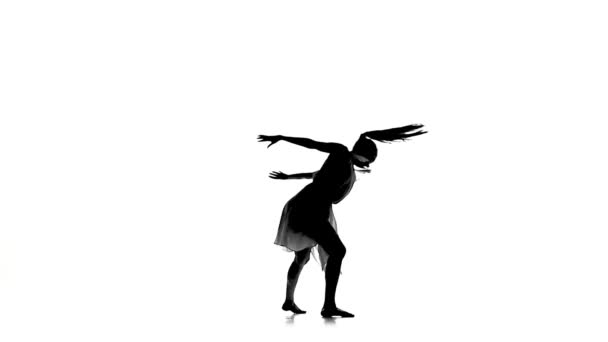 Graceful woman with ponytail dance modern contemporary style on white, silhouette, slow motion - Footage, Video