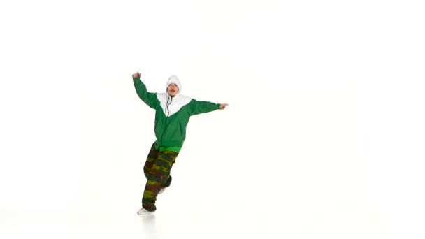 Modern dancer in jacket and hood dancing breakdance on white, slow motion - Séquence, vidéo