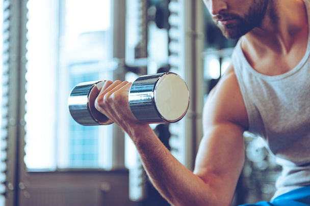 young man with dumbbell - 写真・画像