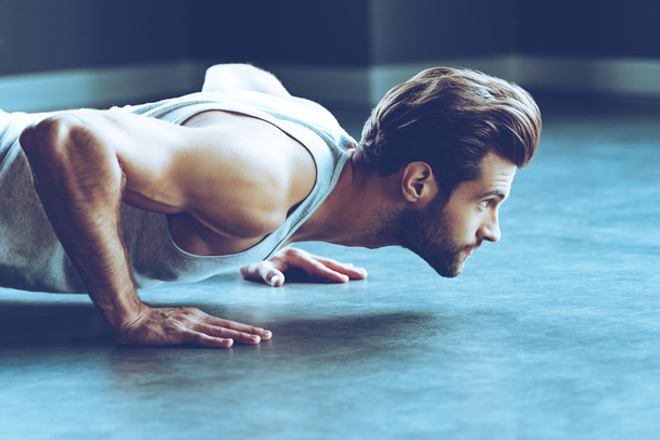 young handsome man doing push-up - 写真・画像