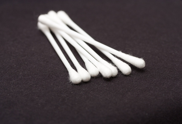 Cotton sticks isolated on black background - Foto, afbeelding