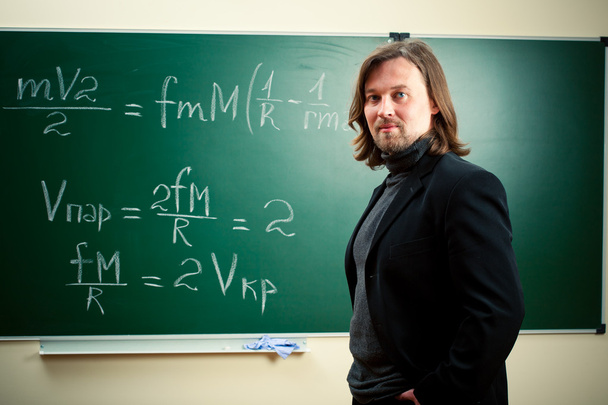 Math teacher against the blackboard - Photo, Image