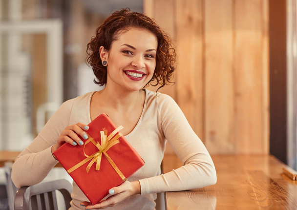 Nice woman holding present - Photo, Image