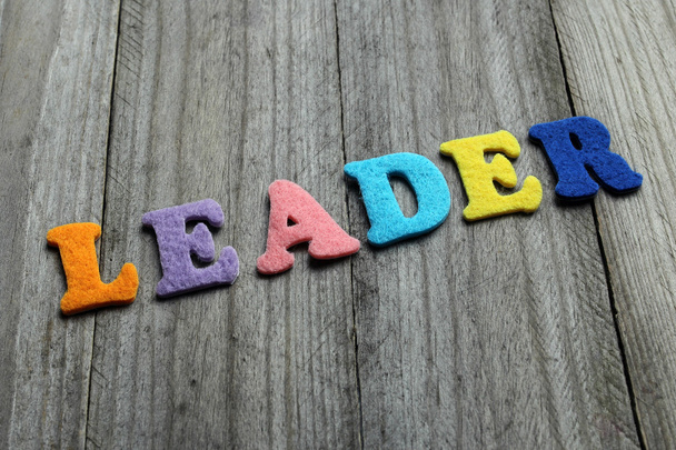 leader word on wooden background - Foto, afbeelding