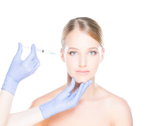 Doctor injecting botox into a woman's face - Fotoğraf, Görsel