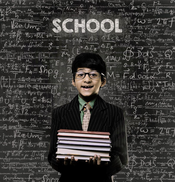 School. Genius Little Boy Holding Book Wearing Glasses Chalkboar - Photo, Image