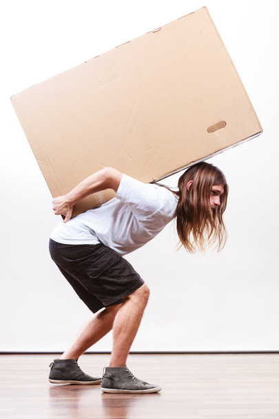 Delivery man holding a paper box. - Фото, зображення
