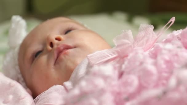 Happy baby girl lying on pink blanket - Footage, Video