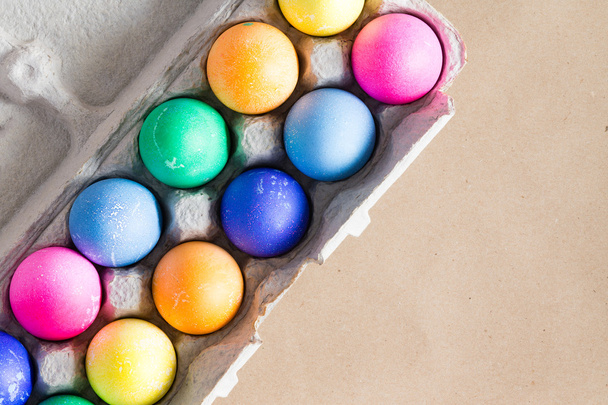 Яскрава рука пофарбовані барвисті великодні яйця в коробку
 - Фото, зображення