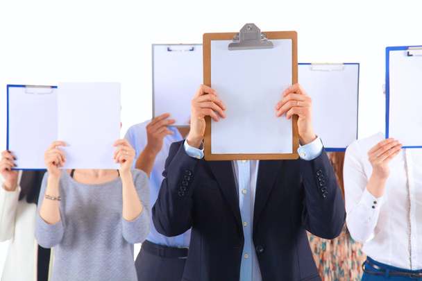Team of businesspeople holding a folders near face isolated on white background - Fotografie, Obrázek