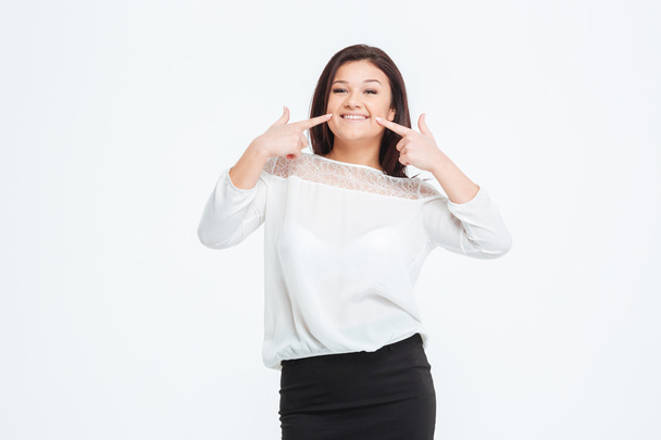 Smiling businesswoman pointing finger at herself - 写真・画像