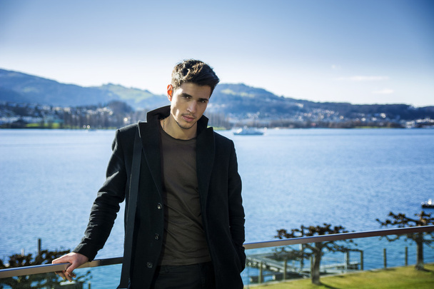 Handsome young man on Luzern lakes shore - Foto, imagen