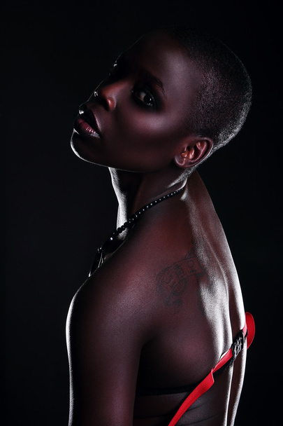 Black African young sexy fashion model studio portrait isolated white black - Fotó, kép