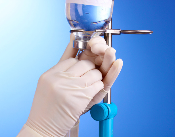 Nurse doing infusion on blue background - Foto, Imagen