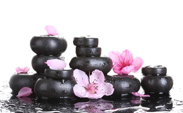 Spa stones with drops and pink sakura flowers on white background - Foto, Bild