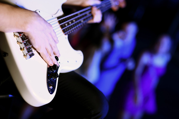 Young guitar player performing in night club - Φωτογραφία, εικόνα