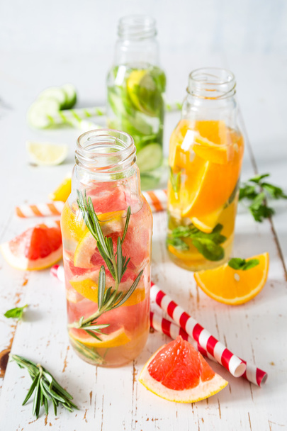 Selection of infused water in glass bottles, rustic wood background - Φωτογραφία, εικόνα