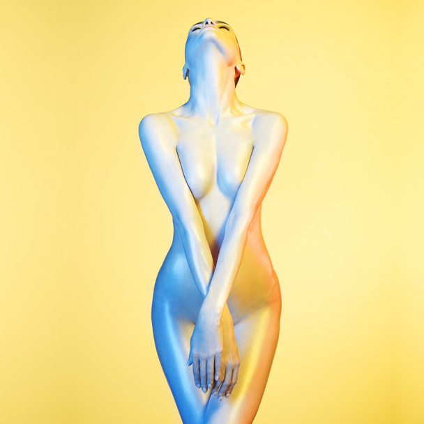 Elegant nude model in the light colored spotlights - Zdjęcie, obraz