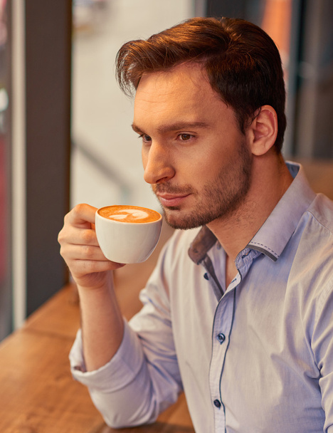 Handsome man drinking coffee - Фото, изображение