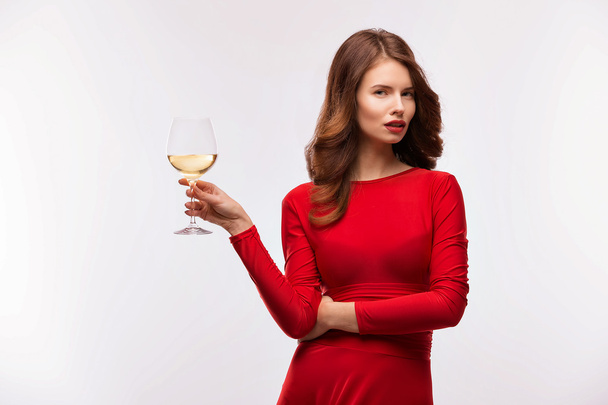 woman in red gown with champagne glass on white - Foto, imagen
