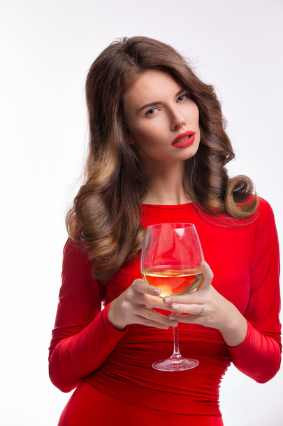 woman in red gown with champagne glass on white - Фото, изображение