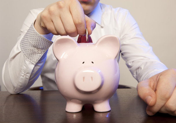 Businessman with pink piggy bank - Foto, afbeelding