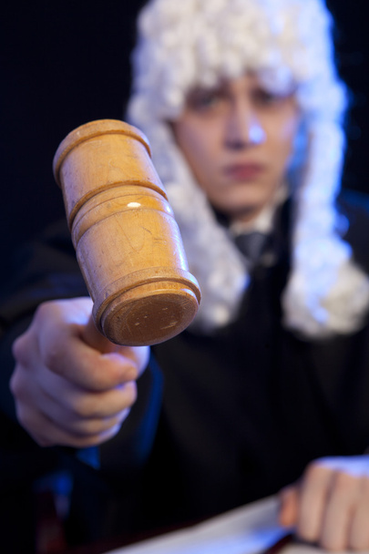 Male judge in a courtroom striking the gavel - Fotoğraf, Görsel