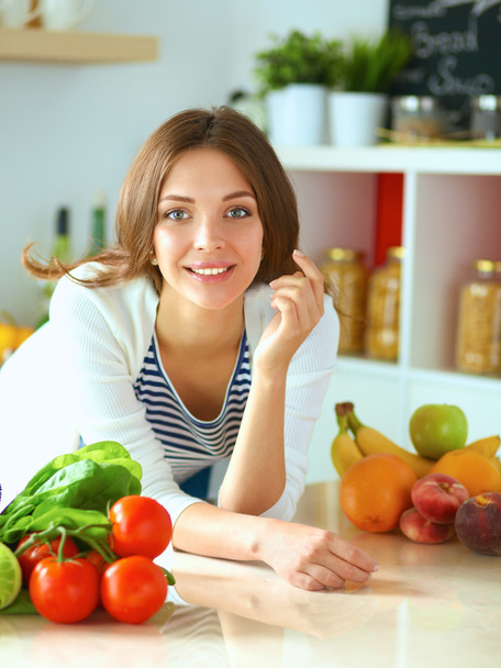 Young woman sitting near desk in the kitchen - Foto, Imagem