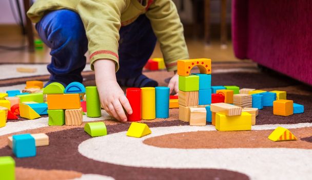Small child playing with wooden blocks - Photo, Image