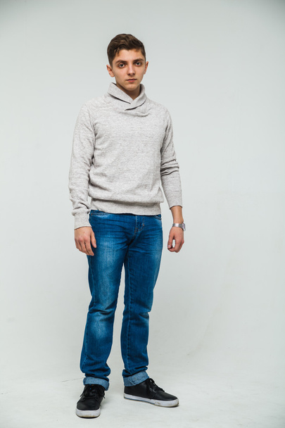 man sweatshirt and jeans white background - Фото, изображение