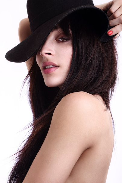Energetic sexy attractive fresh portrait of young woman girl model excited cheering wearing a hat. Beautiful mixed race Black African Caucasian model isolated on white background. Long hair brunette. - Foto, Imagen