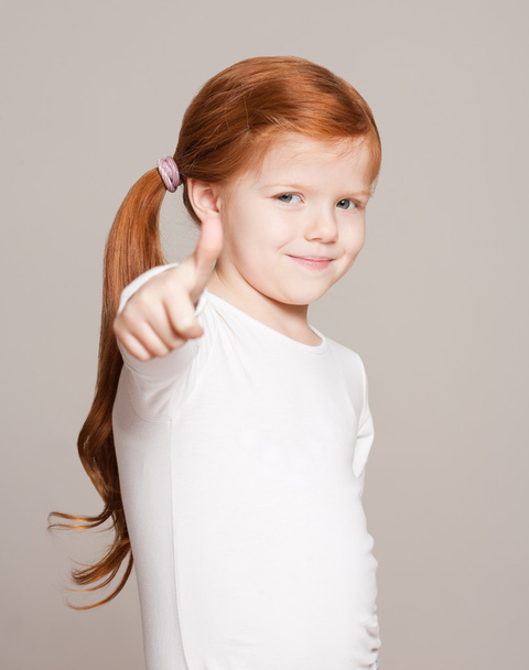 Young girl showing thumbs up. - Fotó, kép