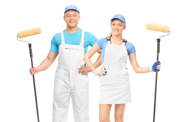 Male and female decorators with paint rollers - Fotoğraf, Görsel