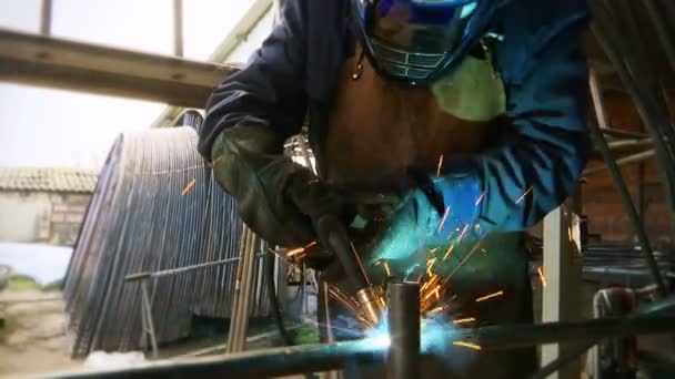 Welder in the workshop performs arc welding - Footage, Video