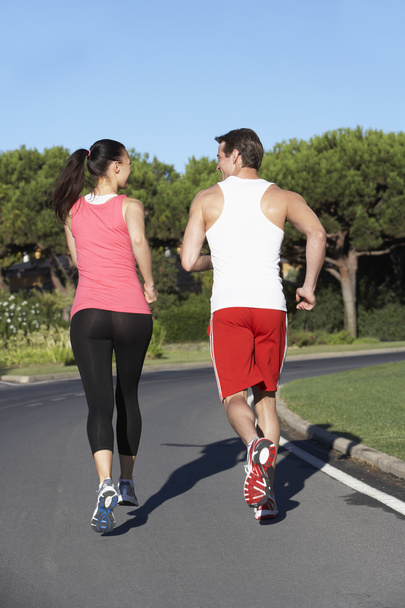 Young Couple Running On Road - Foto, imagen